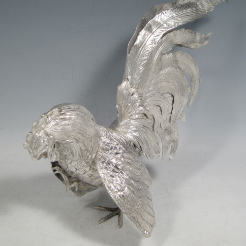 A very handsome Sterling Silver large pair of cast fighting cock cockerels or roosters, showing two male birds in realistic fighting poses, finely detailed with hand-chased bodies and tail feathers. This fantastic pair of silver fighting cocks were made by Francis Higgins of London in 1936. The dimensions of these fine hand-made sterling silver fighting roosters or cockerel cocks are length 30.5 cms (12 inches), height 27 cms (10.75 inches), and they weigh a total of approx. 1,240g (40 troy ounces).