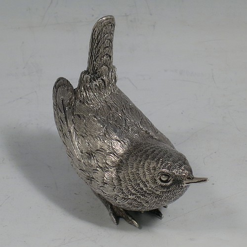 A cast Sterling Silver model of a Wren bird, in a realistic traditional pose, finely detailed with hand-chased body and tail feathers. Made by Robert Glover of London in 1974. The dimensions of this fine hand-made cast sterling silver wren model are length 6 cs (2.3 inches), height 5 cms (2 inches), width 2.5 cms (1 inch), and it weighs approx. 163g (5.25 troy ounces).    