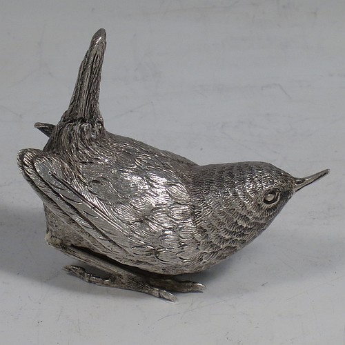 A cast Sterling Silver model of a Wren bird, in a realistic traditional pose, finely detailed with hand-chased body and tail feathers. Made by Robert Glover of London in 1974. The dimensions of this fine hand-made cast sterling silver wren model are length 6 cs (2.3 inches), height 5 cms (2 inches), width 2.5 cms (1 inch), and it weighs approx. 163g (5.25 troy ounces).    