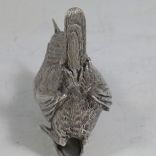 A cast Sterling Silver model of a Wren bird, in a realistic traditional pose, finely detailed with hand-chased body and tail feathers. Made by Robert Glover of London in 1974. The dimensions of this fine hand-made cast sterling silver wren model are length 6 cs (2.3 inches), height 5 cms (2 inches), width 2.5 cms (1 inch), and it weighs approx. 163g (5.25 troy ounces).    