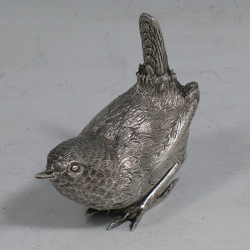 A cast Sterling Silver model of a Wren bird, in a realistic traditional pose, finely detailed with hand-chased body and tail feathers. Made by Robert Glover of London in 1974. The dimensions of this fine hand-made cast sterling silver wren model are length 6 cs (2.3 inches), height 5 cms (2 inches), width 2.5 cms (1 inch), and it weighs approx. 163g (5.25 troy ounces).    