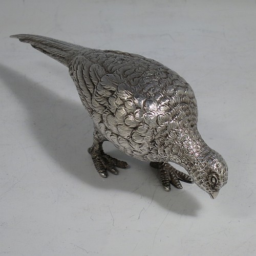 A cast Sterling Silver pair of pheasants, showing a male and female bird in realistic traditional poses, finely detailed with hand-chased bodies and tail feathers. Made by Robert Glover of London in 1973. The dimensions of these fine hand-made sterling silver pheasants are length of male bird 17 cms (6.75 inches), height 8 cms (3 inches), and they weigh a total approx. 310g (10 troy ounces).    