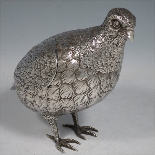 A Sterling Silver large cast model of a partridge bird, having realistically hand-chased feathers, a pull-off head, and hinged wings. Imported and having hallmarks for London in 1925. The dimensions of this fine hand-made silver partridge model are height 16.5 cms (6.5 inches), length 16.5 cms (6.5 inches), width 9 cms (3.5 inches), and it weighs approx. 435g (14 troy ounces).   