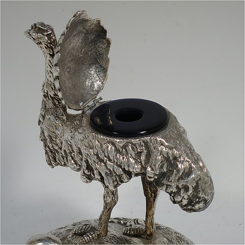 A very unusual Antique Victorian Silver-Plated inkstand and model of an Ostrich, having realistically hand-chased feathers, a hinged lid with an internal blue-glass liner inkwell, and standing on a cast round rock base with six ostrich eggs. Made in ca. 1880. The dimensions of this fine hand-made antique silver plated ostrich model and inkstand are height 15 cms (6 inches), and diameter of base 13 cms (5 inches).    