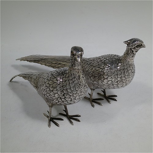 A very handsome pair of Dutch Continental 833 standard Silver pheasants, showing a male and female bird in realistic traditional poses, finely detailed with hand-chased bodies and tail feathers, and with removable heads. Made in Holland in 1948. The dimensions of these fine hand-made silver pheasants are length of male bird 26 cms (10.25 inches), height 12.5 cms (5 inches), and they weigh a total approx. 413g (13.3 troy ounces).    