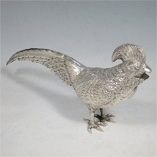 An Antique Edwardian Sterling Silver model of a King Pheasant bird, having realistically hand-chased feathers, a pull-off head, and cast feet. Made in ca. 1900 and imported from Continental Europe. The dimensions of this fine hand-made antique silver King Pheasant bird model are height 11.5 cms (4.5 inches), length 21 cms (8 inches), width 5 cms (2 inches), and it weighs approx. 175g (5.6 troy ounces).    