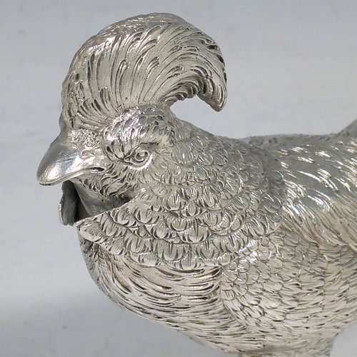 An Antique Edwardian Sterling Silver model of a King Pheasant bird, having realistically hand-chased feathers, a pull-off head, and cast feet. Made in ca. 1900 and imported from Continental Europe. The dimensions of this fine hand-made antique silver King Pheasant bird model are height 11.5 cms (4.5 inches), length 21 cms (8 inches), width 5 cms (2 inches), and it weighs approx. 175g (5.6 troy ounces).    