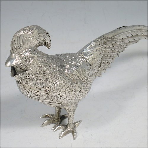 An Antique Edwardian Sterling Silver model of a King Pheasant bird, having realistically hand-chased feathers, a pull-off head, and cast feet. Made in ca. 1900 and imported from Continental Europe. The dimensions of this fine hand-made antique silver King Pheasant bird model are height 11.5 cms (4.5 inches), length 21 cms (8 inches), width 5 cms (2 inches), and it weighs approx. 175g (5.6 troy ounces).    