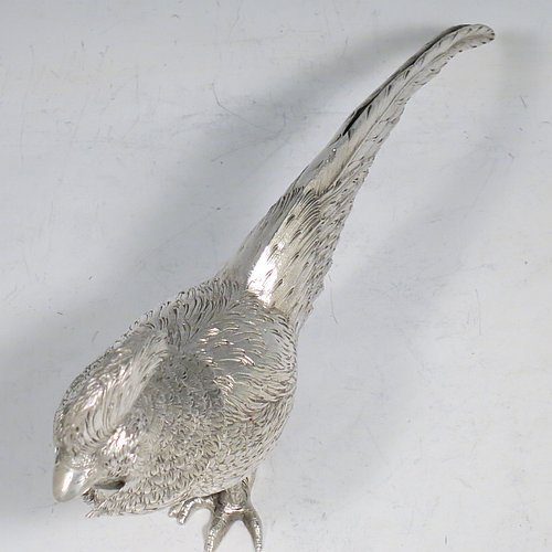 An Antique Edwardian Sterling Silver model of a King Pheasant bird, having realistically hand-chased feathers, a pull-off head, and cast feet. Made in ca. 1900 and imported from Continental Europe. The dimensions of this fine hand-made antique silver King Pheasant bird model are height 11.5 cms (4.5 inches), length 21 cms (8 inches), width 5 cms (2 inches), and it weighs approx. 175g (5.6 troy ounces).    