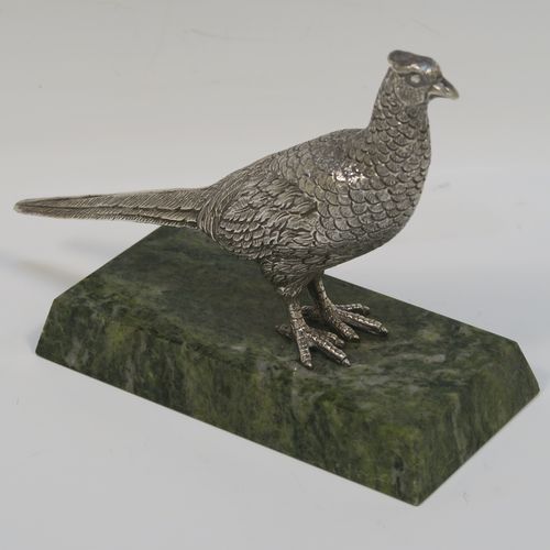 A very handsome cast Sterling Silver model of a  pheasant, showing a male bird in a realistic traditional pose, finely detailed with hand-chased body and tail feathers, all mounted on a green Connemara marble base. This beautiful cast silver pheasant model bird was made by A. E. Jones of Birmingham in 1968. The dimensions of this fine hand-made cast silver pheasant 16.5 cms (6.5 inches), height 10 cms (4 inches), with an aprrox. weight of 250g (8 troy ounces.  