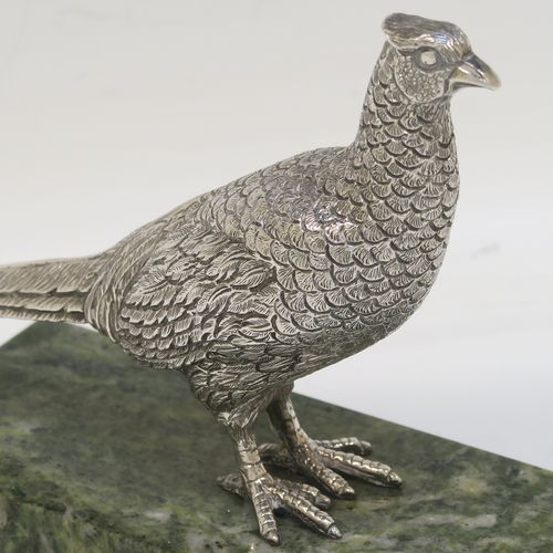 A very handsome cast Sterling Silver model of a  pheasant, showing a male bird in a realistic traditional pose, finely detailed with hand-chased body and tail feathers, all mounted on a green Connemara marble base. This beautiful cast silver pheasant model bird was made by A. E. Jones of Birmingham in 1968. The dimensions of this fine hand-made cast silver pheasant 16.5 cms (6.5 inches), height 10 cms (4 inches), with an aprrox. weight of 250g (8 troy ounces.  