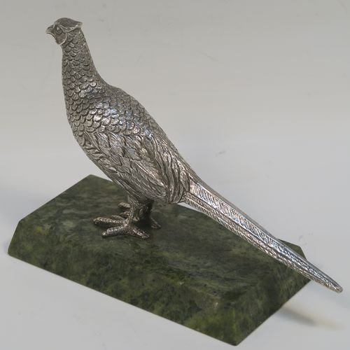 A very handsome cast Sterling Silver model of a  pheasant, showing a male bird in a realistic traditional pose, finely detailed with hand-chased body and tail feathers, all mounted on a green Connemara marble base. This beautiful cast silver pheasant model bird was made by A. E. Jones of Birmingham in 1968. The dimensions of this fine hand-made cast silver pheasant 16.5 cms (6.5 inches), height 10 cms (4 inches), with an aprrox. weight of 250g (8 troy ounces.  