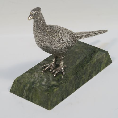 A very handsome cast Sterling Silver model of a  pheasant, showing a male bird in a realistic traditional pose, finely detailed with hand-chased body and tail feathers, all mounted on a green Connemara marble base. This beautiful cast silver pheasant model bird was made by A. E. Jones of Birmingham in 1968. The dimensions of this fine hand-made cast silver pheasant 16.5 cms (6.5 inches), height 10 cms (4 inches), with an aprrox. weight of 250g (8 troy ounces.  