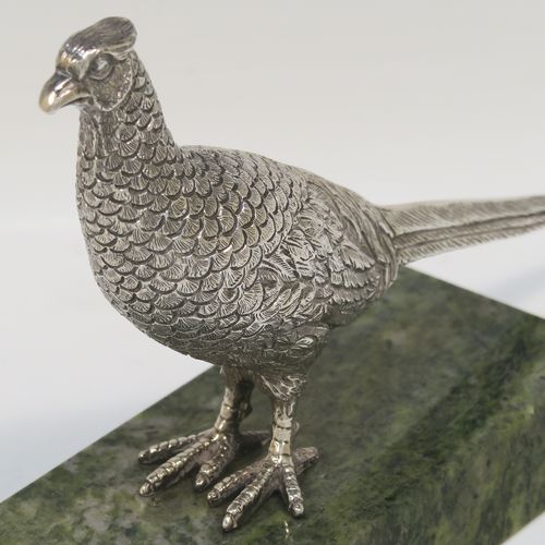 A very handsome cast Sterling Silver model of a  pheasant, showing a male bird in a realistic traditional pose, finely detailed with hand-chased body and tail feathers, all mounted on a green Connemara marble base. This beautiful cast silver pheasant model bird was made by A. E. Jones of Birmingham in 1968. The dimensions of this fine hand-made cast silver pheasant 16.5 cms (6.5 inches), height 10 cms (4 inches), with an aprrox. weight of 250g (8 troy ounces.  