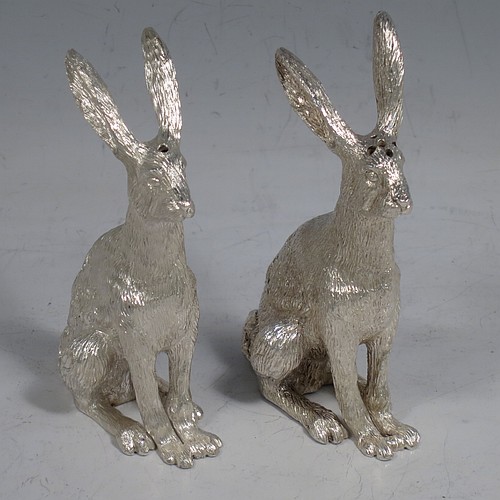 A cast Sterling Silver pair of hares, showing two  male hares in realistic traditional poses, finely detailed with hand-chased bodies, made hollow for use as salt and pepper shakers. Made by William Comyns of London in 2016. The dimensions of these fine hand-made sterling silver hare model salt and pepper shakers are length 5 cms (2 inches), height 8.5 cms (3.3 inches), and they weigh a total approx. 230g (7.4 troy ounces).    