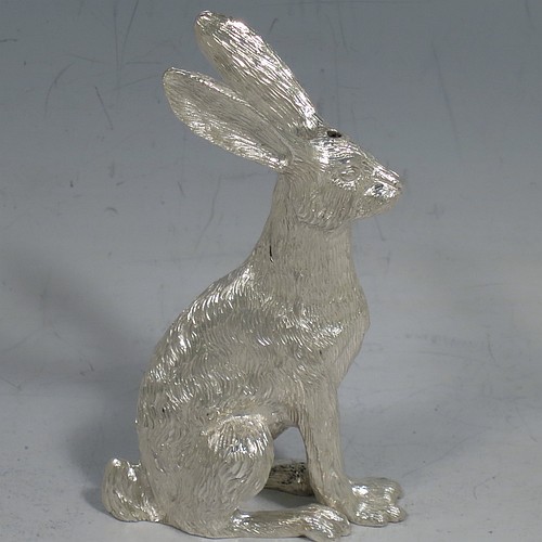 A cast Sterling Silver pair of hares, showing two  male hares in realistic traditional poses, finely detailed with hand-chased bodies, made hollow for use as salt and pepper shakers. Made by William Comyns of London in 2016. The dimensions of these fine hand-made sterling silver hare model salt and pepper shakers are length 5 cms (2 inches), height 8.5 cms (3.3 inches), and they weigh a total approx. 230g (7.4 troy ounces).    