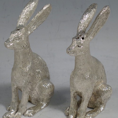 A cast Sterling Silver pair of hares, showing two  male hares in realistic traditional poses, finely detailed with hand-chased bodies, made hollow for use as salt and pepper shakers. Made by William Comyns of London in 2016. The dimensions of these fine hand-made sterling silver hare model salt and pepper shakers are length 5 cms (2 inches), height 8.5 cms (3.3 inches), and they weigh a total approx. 230g (7.4 troy ounces).    