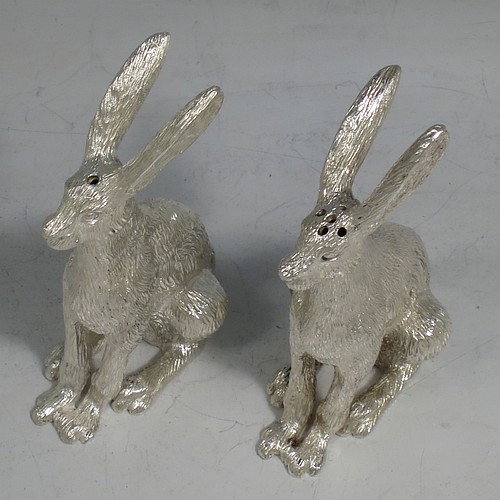 A cast Sterling Silver pair of hares, showing two  male hares in realistic traditional poses, finely detailed with hand-chased bodies, made hollow for use as salt and pepper shakers. Made by William Comyns of London in 2016. The dimensions of these fine hand-made sterling silver hare model salt and pepper shakers are length 5 cms (2 inches), height 8.5 cms (3.3 inches), and they weigh a total approx. 230g (7.4 troy ounces).    