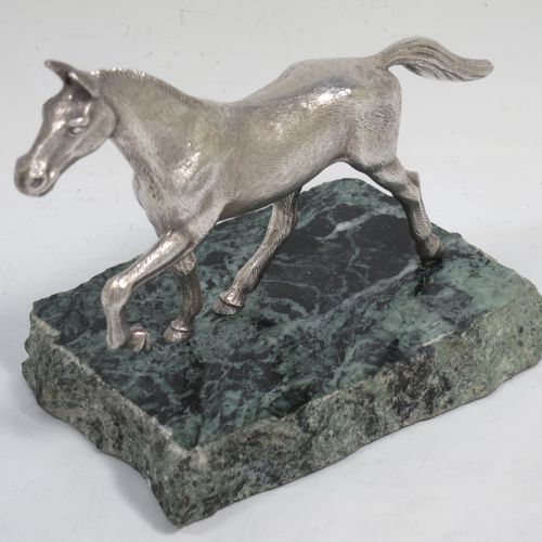 A handsome Sterling Silver cast model of a horse in a cantering pose, and fixed to a green marble base. Made by Albert Edward Jones of Birmingham in 1972. The dimensions of this fine hand-made silver horse are height 11.5 cms (4.5 inches), and length 15 cms (6 inches).   