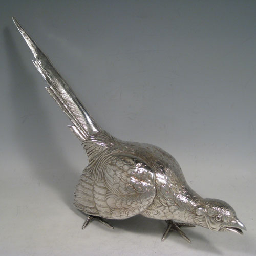 Sterling silver large cast model of a pheasant cock bird, having realistically hand-chased feathers. Imported and having hallmarks for London in 1926. Height 21.5 cms (8.5 inches), length 35 cms (13.75 inches), width 8 cms (3 inches). Weight approx. 412g (13.3 troy ounces).