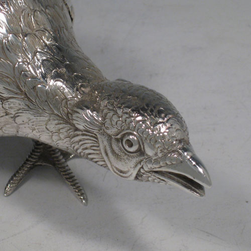 Sterling silver large cast model of a pheasant cock bird, having realistically hand-chased feathers. Imported and having hallmarks for London in 1926. Height 21.5 cms (8.5 inches), length 35 cms (13.75 inches), width 8 cms (3 inches). Weight approx. 412g (13.3 troy ounces).