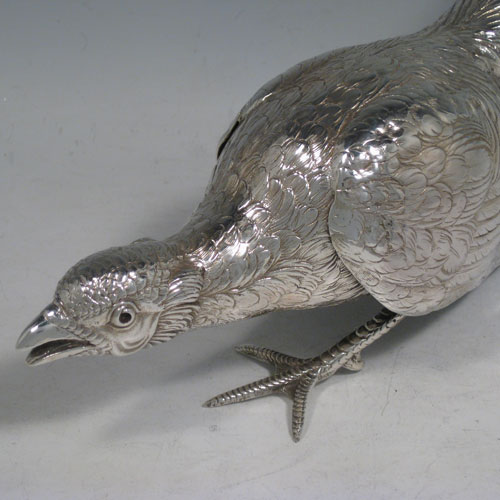 Sterling silver large cast model of a pheasant cock bird, having realistically hand-chased feathers. Imported and having hallmarks for London in 1926. Height 21.5 cms (8.5 inches), length 35 cms (13.75 inches), width 8 cms (3 inches). Weight approx. 412g (13.3 troy ounces).