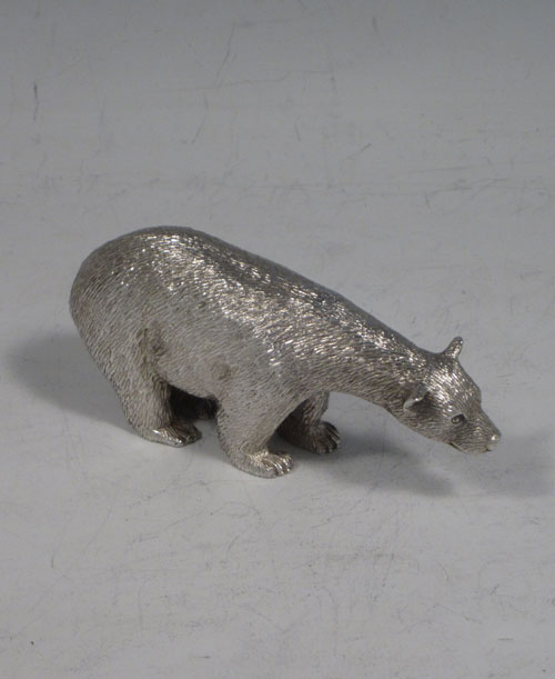 Sterling silver cast model of a standing polar bear, having realistically hand-chased fur, with fine detail. Made by Robert Comyns of London in 1989. The dimensions of this fine hand-made silver polar bear are length 9 cms (3.5 inches), height 4.5 cms (1.75 inches), and it weighs approx. 160g (5.2 troy ounces).   