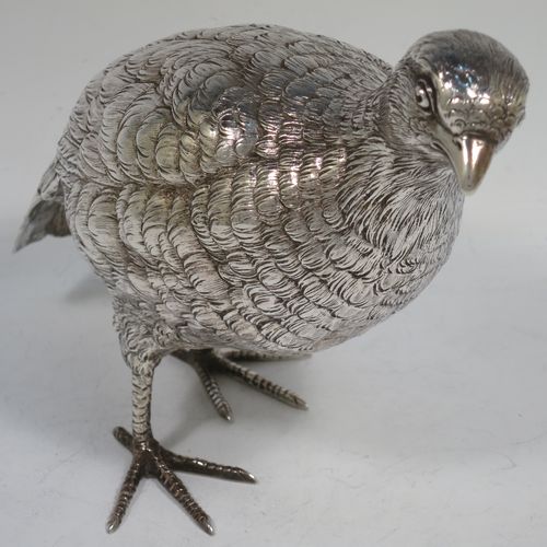 A very handsome and large pair of Sterling Silver partridge bird models, having realistically hand-chased feathers, faces, and feet. Bearing Import marks for London 1934. The dimensions of this fine hand-made sterling silver pair of partridge model birds are height 14 cms (5.5 inches), length 20 cms (8 inches), width 8 cms (3 inches), and they weigh a total of approx. 753g (24 troy ounces).    