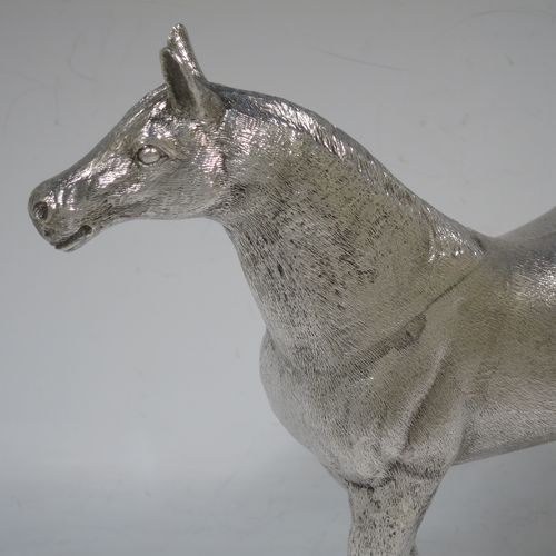 A very handsome, large, and heavy Sterling Silver cast model of a horse in a standing pose, all realistically hand-chased. Made by SMD Castings of London in 1973. The dimensions of this fine hand-made silver horse are height 20 cms (8 inches), length 24 cms (9.5 inches), and it weighs approx. 1,310g (42 troy ounces).    