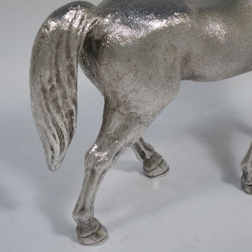 A very handsome, large, and heavy Sterling Silver cast model of a horse in a standing pose, all realistically hand-chased. Made by SMD Castings of London in 1973. The dimensions of this fine hand-made silver horse are height 20 cms (8 inches), length 24 cms (9.5 inches), and it weighs approx. 1,310g (42 troy ounces).    