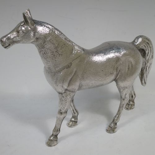 A very handsome, large, and heavy Sterling Silver cast model of a horse in a standing pose, all realistically hand-chased. Made by SMD Castings of London in 1973. The dimensions of this fine hand-made silver horse are height 20 cms (8 inches), length 24 cms (9.5 inches), and it weighs approx. 1,310g (42 troy ounces).    