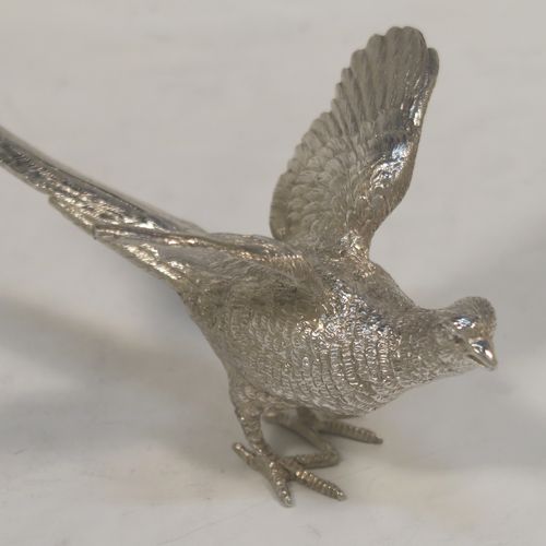 A very handsome Sterling Silver pair of solid cast pheasants, showing a male and female bird in realistic traditional poses, finely detailed with hand-chased bodies and tail feathers. These beautiful silver pheasants were made by C. J. Vander of Sheffield in 1995. The dimensions of these fine hand-made sterling silver pheasants are length of female bird 13.5 cms (5.25 inches), spread across wings 8 cms (6 inches), height of male bird to top of head 6 cms (2.3 inches), and they weigh a total approx. 305g (9.8 troy ounces).  