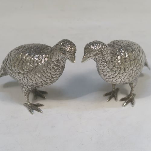 A very handsome Sterling Silver pair of solid cast partridges, showing a male and female bird in realistic traditional poses, finely detailed with hand-chased bodies and tail feathers. These beautiful silver partridges were made by Edward Barnard of London in 1979. The dimensions of these fine hand-made sterling silver partridges are length 10 cms (4 inches), width 4 cms (1.5 inches), height 8 cms (3.25 inches), and they weigh a total approx. 342g (11 troy ounces).   