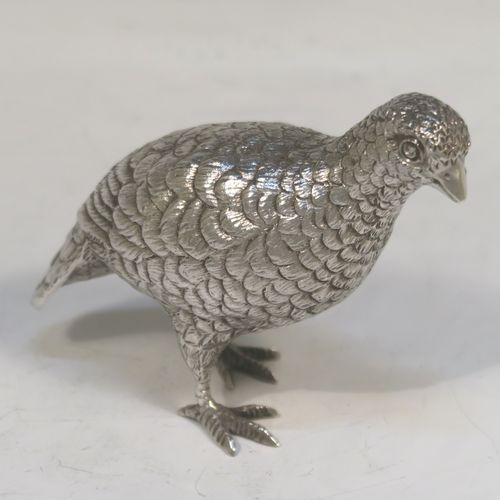 A very handsome Sterling Silver pair of solid cast partridges, showing a male and female bird in realistic traditional poses, finely detailed with hand-chased bodies and tail feathers. These beautiful silver partridges were made by Edward Barnard of London in 1979. The dimensions of these fine hand-made sterling silver partridges are length 10 cms (4 inches), width 4 cms (1.5 inches), height 8 cms (3.25 inches), and they weigh a total approx. 342g (11 troy ounces).   