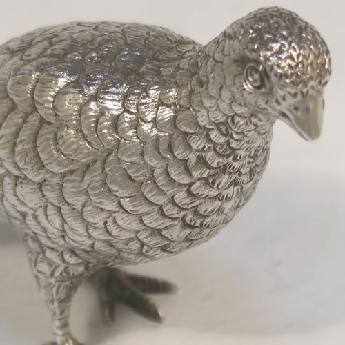 A very handsome Sterling Silver pair of solid cast partridges, showing a male and female bird in realistic traditional poses, finely detailed with hand-chased bodies and tail feathers. These beautiful silver partridges were made by Edward Barnard of London in 1979. The dimensions of these fine hand-made sterling silver partridges are length 10 cms (4 inches), width 4 cms (1.5 inches), height 8 cms (3.25 inches), and they weigh a total approx. 342g (11 troy ounces).   