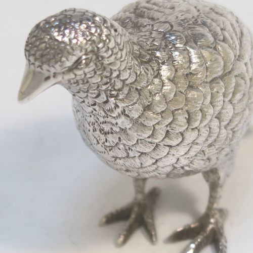 A very handsome Sterling Silver pair of solid cast partridges, showing a male and female bird in realistic traditional poses, finely detailed with hand-chased bodies and tail feathers. These beautiful silver partridges were made by Edward Barnard of London in 1979. The dimensions of these fine hand-made sterling silver partridges are length 10 cms (4 inches), width 4 cms (1.5 inches), height 8 cms (3.25 inches), and they weigh a total approx. 342g (11 troy ounces).   