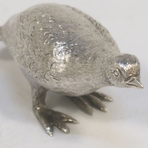 A handsome Sterling Silver solid cast model of a partridge bird, in a pose and having realistically hand-chased feathers. This elegant silver partridge model was made by Robert Comyns of London in 1971. The dimensions of this fine hand-made silver partridge model are height 3.5 cms (1.3 inches), length 7.5 cms (3 inches), width 3 cms (1.25 inches), and it weighs approx. 51g (1.6 troy ounces).   