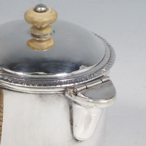 Antique Georgian sterling silver Argyll, having a plain round body with straight sides, a hinged lid with ivory finial, a scroll-shaped spout, a scroll handle with wicker-work insulation, a separate side spout with hinged lid for adding hot water, and sitting on a flat base. Made by Philip Norman of London in 1768. The dimensions of this fine hand-made silver Argyll are height 11.5 cms (4.5 inches), diameter 8 cms (3 inches), and it weighs approx. 390g (12.6 troy ounces).