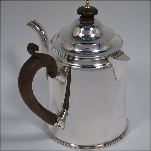 An Antique Edwardian Silver Plated Argyll, having a plain round body with tapering sides and applied reeded borders, a stepped pull-off lid with wooden finial, a scroll pouring spout, a wooden scroll handle, a separate side spout with hinged lid for adding hot water to the water jacket, and all sitting on a flat base. Made in ca. 1910. The dimensions of this fine hand-made antique silver-plated Argyll are height 15 cms (6 inches), diameter at base 10 cms (4 inches), and length across spouts 15 cms (6 inches).    