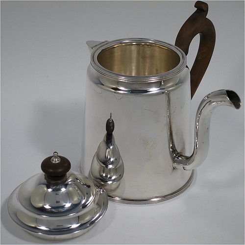 An Antique Edwardian Silver Plated Argyll, having a plain round body with tapering sides and applied reeded borders, a stepped pull-off lid with wooden finial, a scroll pouring spout, a wooden scroll handle, a separate side spout with hinged lid for adding hot water to the water jacket, and all sitting on a flat base. Made in ca. 1910. The dimensions of this fine hand-made antique silver-plated Argyll are height 15 cms (6 inches), diameter at base 10 cms (4 inches), and length across spouts 15 cms (6 inches).    