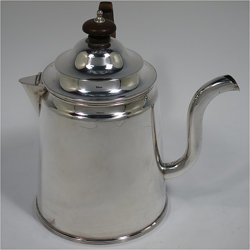 An Antique Edwardian Silver Plated Argyll, having a plain round body with tapering sides and applied reeded borders, a stepped pull-off lid with wooden finial, a scroll pouring spout, a wooden scroll handle, a separate side spout with hinged lid for adding hot water to the water jacket, and all sitting on a flat base. Made in ca. 1910. The dimensions of this fine hand-made antique silver-plated Argyll are height 15 cms (6 inches), diameter at base 10 cms (4 inches), and length across spouts 15 cms (6 inches).    