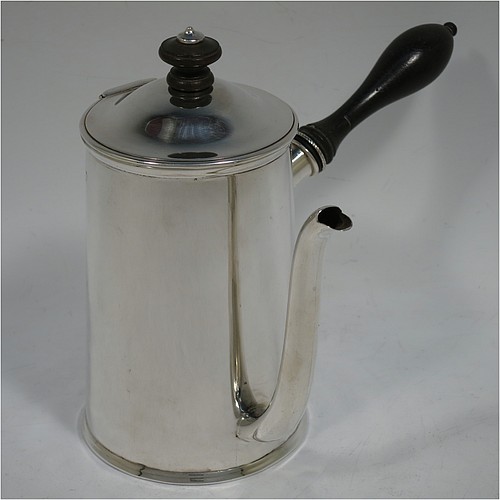 A very handsome Antique Victorian Sterling Silver gravy Argyll, having a plain round body with tapering sides and applied reeded borders, a domed hinged lid with wooden finial, a scroll pouring spout, a wooden handle that unscrews to reveal an opening for adding hot water to the water jacket, and all sitting on a flat base. Made D. and J. Welby of London in 1887. The dimensions of this fine hand-made antique silver Argyll are height 15 cms (6 inches), diameter at base 8.5 cms (3.3 inches), length 12 cms (4.75 inches), and it weighs approx. 350g (11.3 troy ounces).    