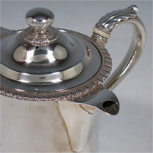 An Antique Victorian Sterling Silver Argyll, having a plain round body with straight sides and an applied gadroon border, a pull-off lid with ball finial, a sparrow-beak spout, a scroll handle with anthemion leaf thumb-piece and bone insulation, a separate side spout with hinged lid for adding hot water to the water jacket, and sitting on a flat base. Made by Thomas Henry & Frederick Francis of London in 1861. The dimensions of this fine hand-made antique silver Argyll are height 12.5 cms (5 inches), diameter 9 cms (3.5 inches), and it weighs approx. 465g (15 troy ounces). Please note that this item is crested.