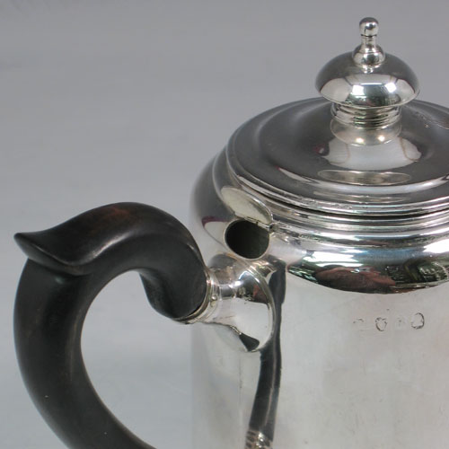 Antique Georgian sterling silver Argyll, having a plain round body with straight sides, a pull-off lid with silver finial, a short pouring spout, a wooden scroll handle, a side hole with hinged lid for adding hot water, and sitting on a flat base. Made by Richard Sibley I of London in 1812. The dimensions of this fine hand-made silver Argyll are height 13.5 cms (5.25 inches), diameter 8.5 cms (3.3 inches), and it weighs approx. 500g (16 troy ounces). Please note that this item is crested.