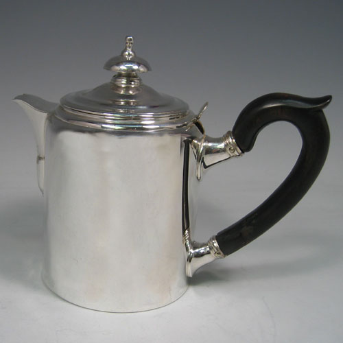 Antique Georgian sterling silver Argyll, having a plain round body with straight sides, a pull-off lid with silver finial, a short pouring spout, a wooden scroll handle, a side hole with hinged lid for adding hot water, and sitting on a flat base. Made by Richard Sibley I of London in 1812. The dimensions of this fine hand-made silver Argyll are height 13.5 cms (5.25 inches), diameter 8.5 cms (3.3 inches), and it weighs approx. 500g (16 troy ounces). Please note that this item is crested.