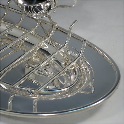 An Antique Edwardian Silver Plated asparagus serving set, having a plain oval body, with an applied rounded border, an original wire-work serving rack, a sauce boat sat in a frame with loop handle, and all sitting on a flat base. Made by Charles Green & Co., of Sheffield in ca. 1900. The dimensions of this fine hand-made silver-plated asparagus serving set are length 34 cms (13.5 inches), and width, 19 cms (7.5 inches).    