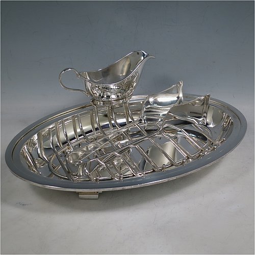 A Silver Plated asparagus serving set, having a plain oval body, with an applied rounded border, an original wire-work serving rack, a pair of plain serving tongs, and a sauce boat sat in a frame with loop handle, and all sitting on a flat base. Made by Deakin & Frances of Sheffield in ca. 1920. The dimensions of this fine hand-made silver-plated asparagus serving set are length 30.5 cms (12 inches), and width, 19.5 cms (7.75 inches).   