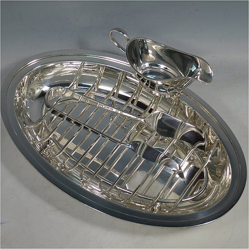 A Silver Plated asparagus serving set, having a plain oval body, with an applied rounded border, an original wire-work serving rack, a pair of plain serving tongs, and a sauce boat sat in a frame with loop handle, and all sitting on a flat base. Made by Deakin & Frances of Sheffield in ca. 1920. The dimensions of this fine hand-made silver-plated asparagus serving set are length 30.5 cms (12 inches), and width, 19.5 cms (7.75 inches).   