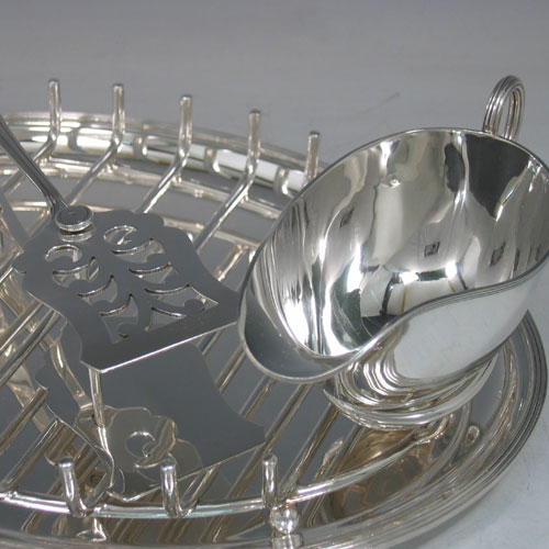    Edwardian sterling silver asparagus serving set with original rack, plate and sauce boat, all made by Maxfield & Sons of Sheffield in 1909. Together with a matching pair of tongs made by Thomas Bradbury & Sons of Sheffield in 1933. Length 30 cms, width, 22 cms, total weight of silver 36 troy ounces.