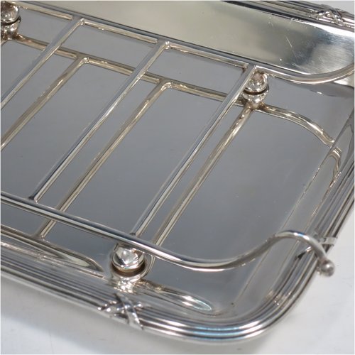 An Antique Edwardian Sterling Silver asparagus serving set, having a plain rectangular body with rounded corners, an applied Ribbon & Reed border, an original wire-work serving rack, and all sitting on a base with four cushion feet. Made by Mappin & Webb of Sheffield in 1909. The dimensions of this fine hand-made antique silver asparagus serving set are length 27 cms (10.5 inches), and width, 19 cms (7.5 inches), and it weighs approx. 727g (23.5 troy ounces).